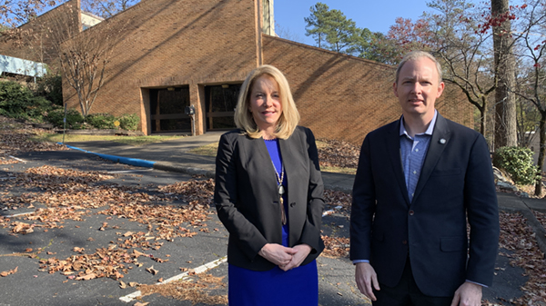 Amy S. Allen (left), BHS president and CEO, and Chris Crain, BMBA executive director, stand outside the building that BHS voted Dec. 7 to gift to BMBA for its new offices. (Photo by Grace Thornton)